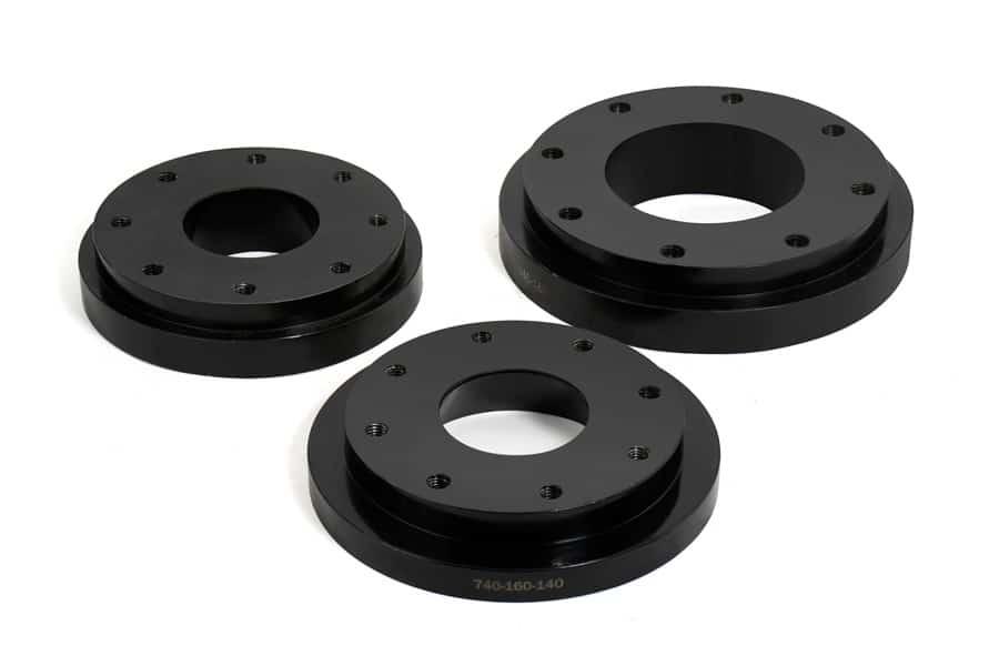Three black painted flanges on a white background
